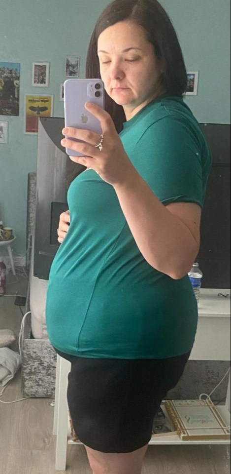 Pregnant woman taking a selfie.