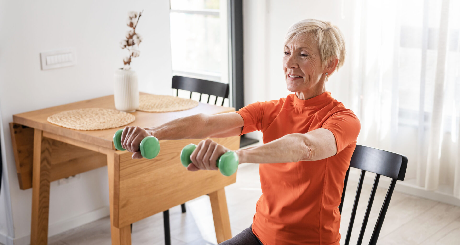 a photo of a senior woman doing exercises in a chair