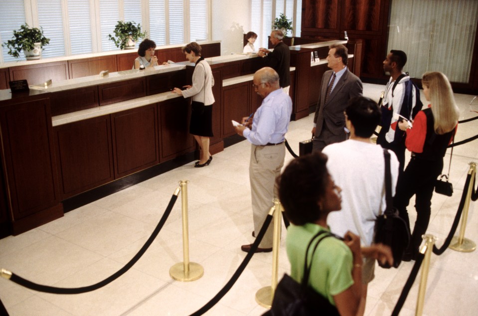 People waiting in line at a bank.