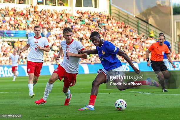 Thierno Barry (in the blue kit for France) was a constant danger.  (Photo by Andrzej Iwanczuk/NurPhoto via Getty Images)
