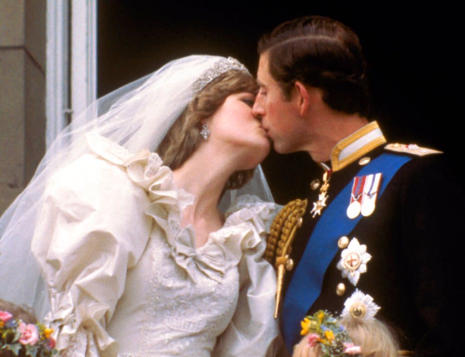 FILE – In this July 29, 1981 file photo, Britain’s Prince Charles kisses his bride, Princess Diana, on the balcony of Buckingham Palace in London, after their wedding.For someone who began her life in the spotlight as “Shy Di,” Princess Diana became an unlikely, revolutionary during her years in the House of Windsor. She helped modernize the monarchy by making it more personal, changing the way the royal family related to people. By interacting more intimately with the public — kneeling to the level of children, sitting on edge of a patient’s hospital bed, writing personal notes to her fans — she set an example that has been followed by other royals as the monarchy worked to become more human and remain relevant in the 21st century. (AP Photo/File)