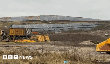A landfill site in the middle of a grassy area