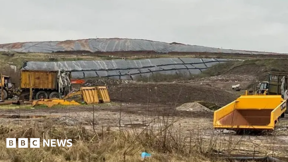 A landfill site in the middle of a grassy area