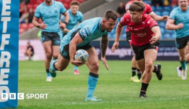 Cade Cust dives over for a try near the posts for Hull FC