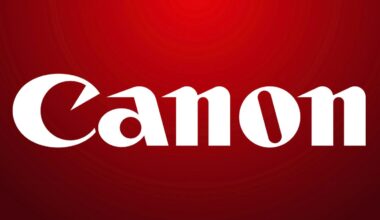 White "Canon" logo in bold, stylized font centered on a red gradient background.