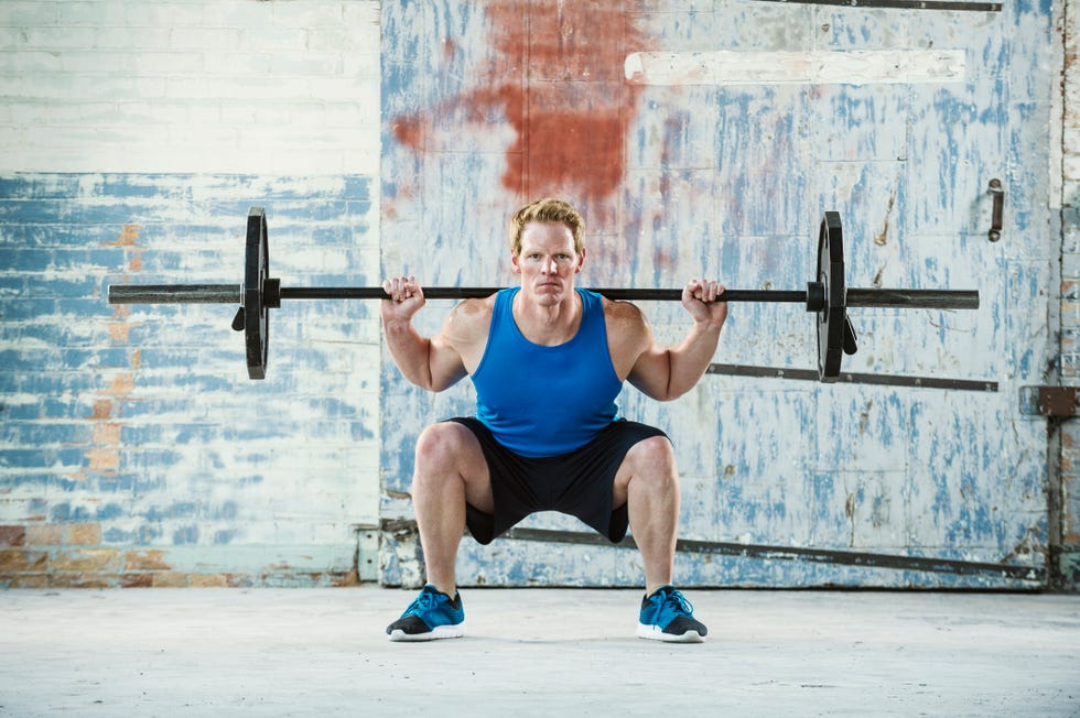 caucasian man lifting weights in warehouse