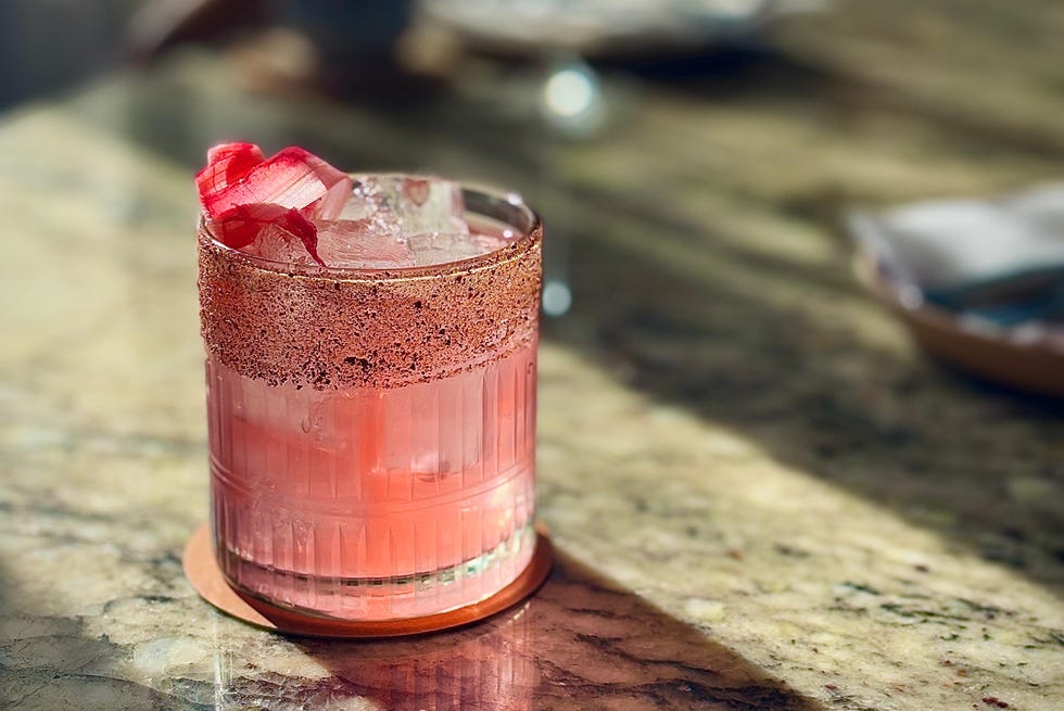 a pink drink on a marble bar