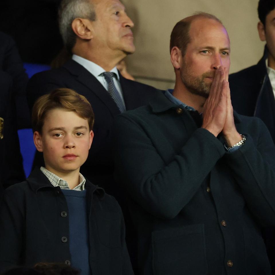 Prince George and Prince William attend a football match