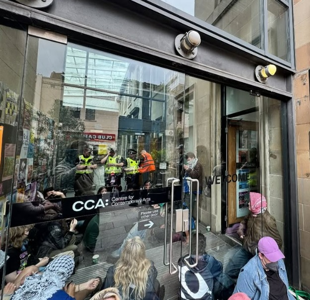 Protestors sitting outside the Centre for Contemporary Arts.