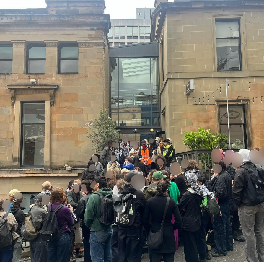 Protesters gathered outside a building.