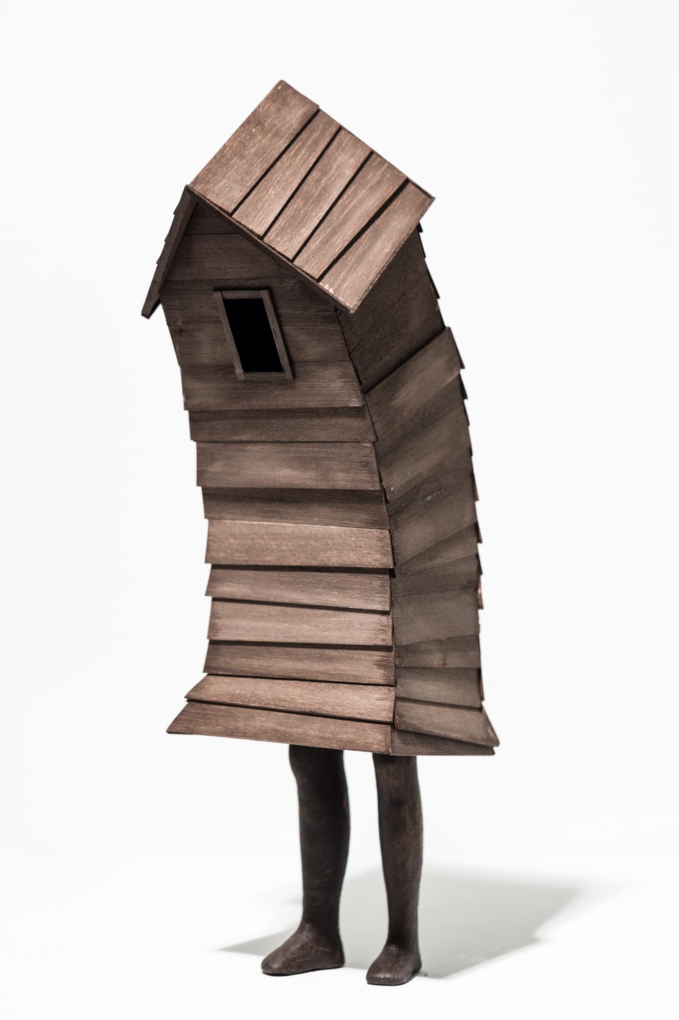 a small sculpture of a small building with two legs