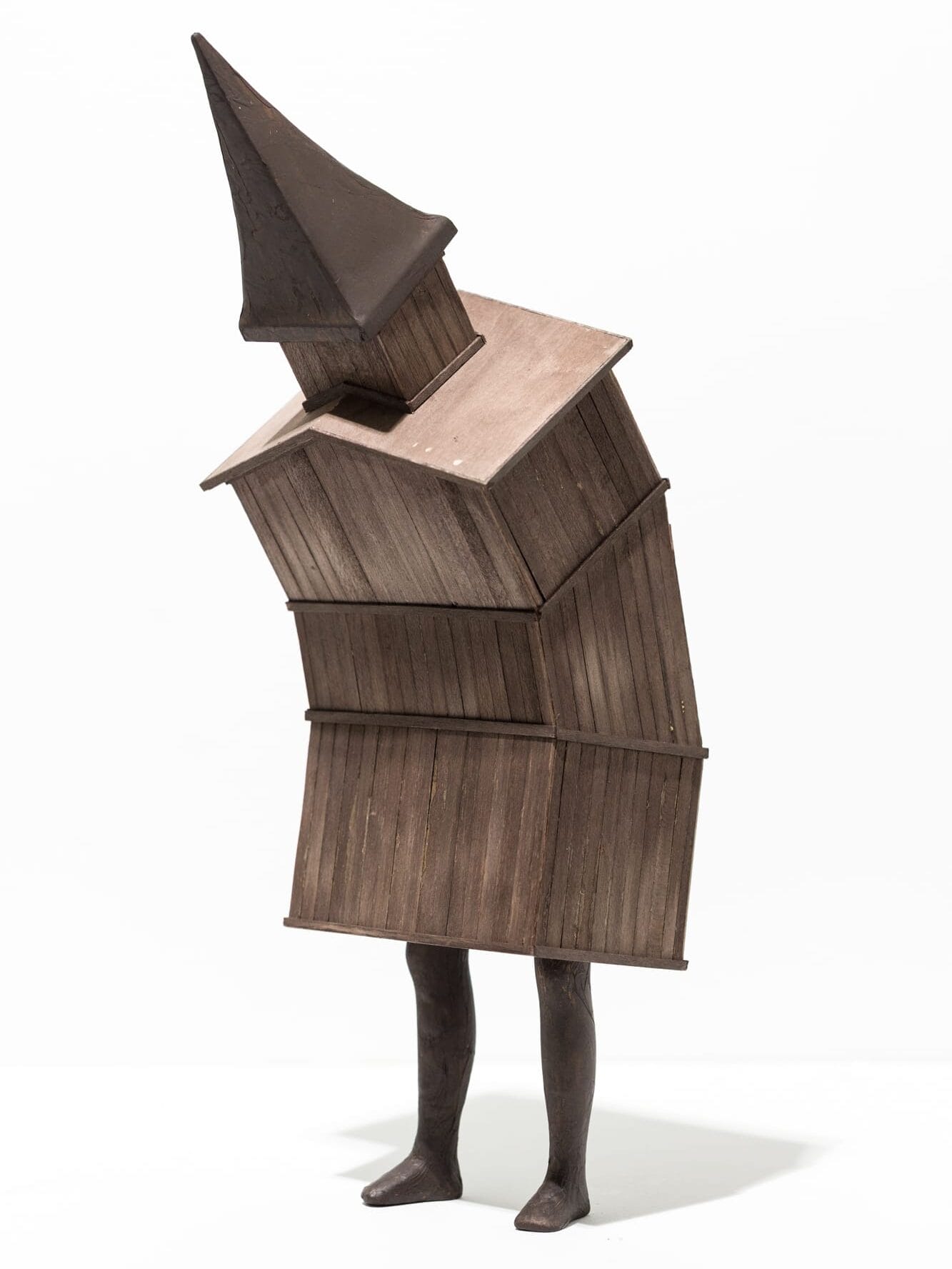 a small sculpture of a small building with two legs