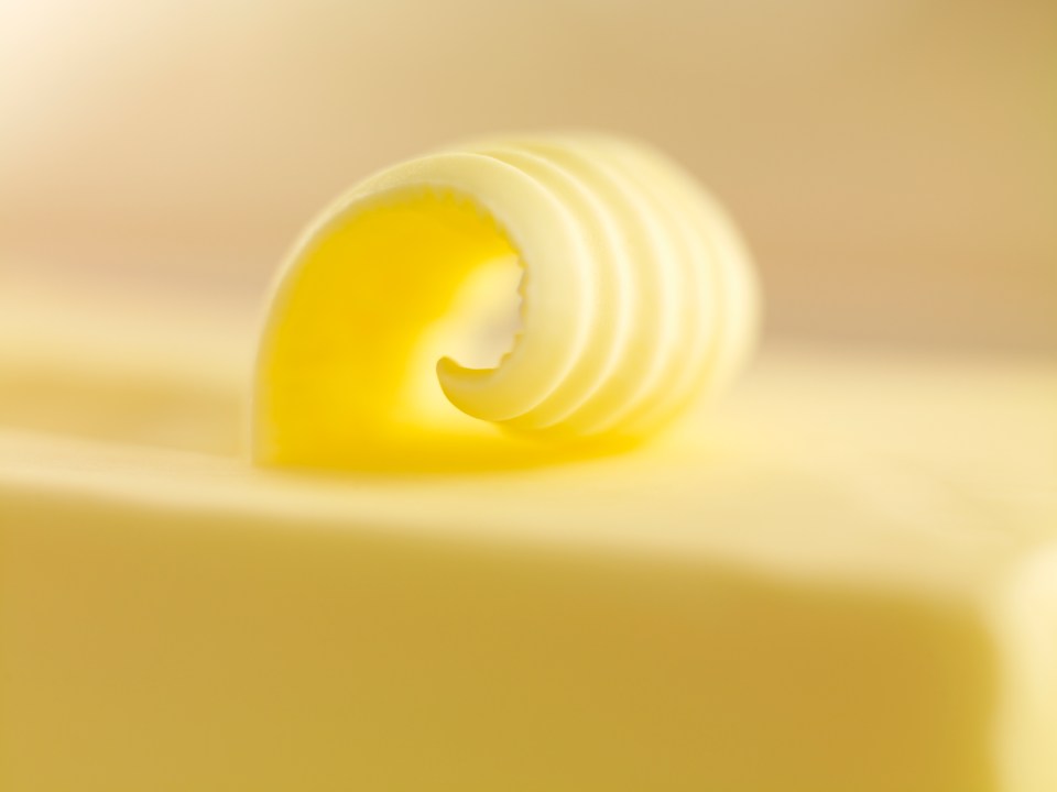 Close-up of a curl of butter on a stick of butter.