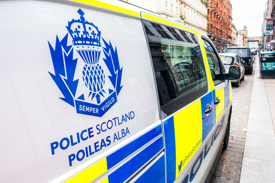Close-up of Police Scotland insignia on a police van.