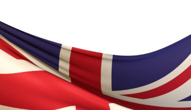 Closeup shot of a wavy flag of the UK under the lights isolated on a white background