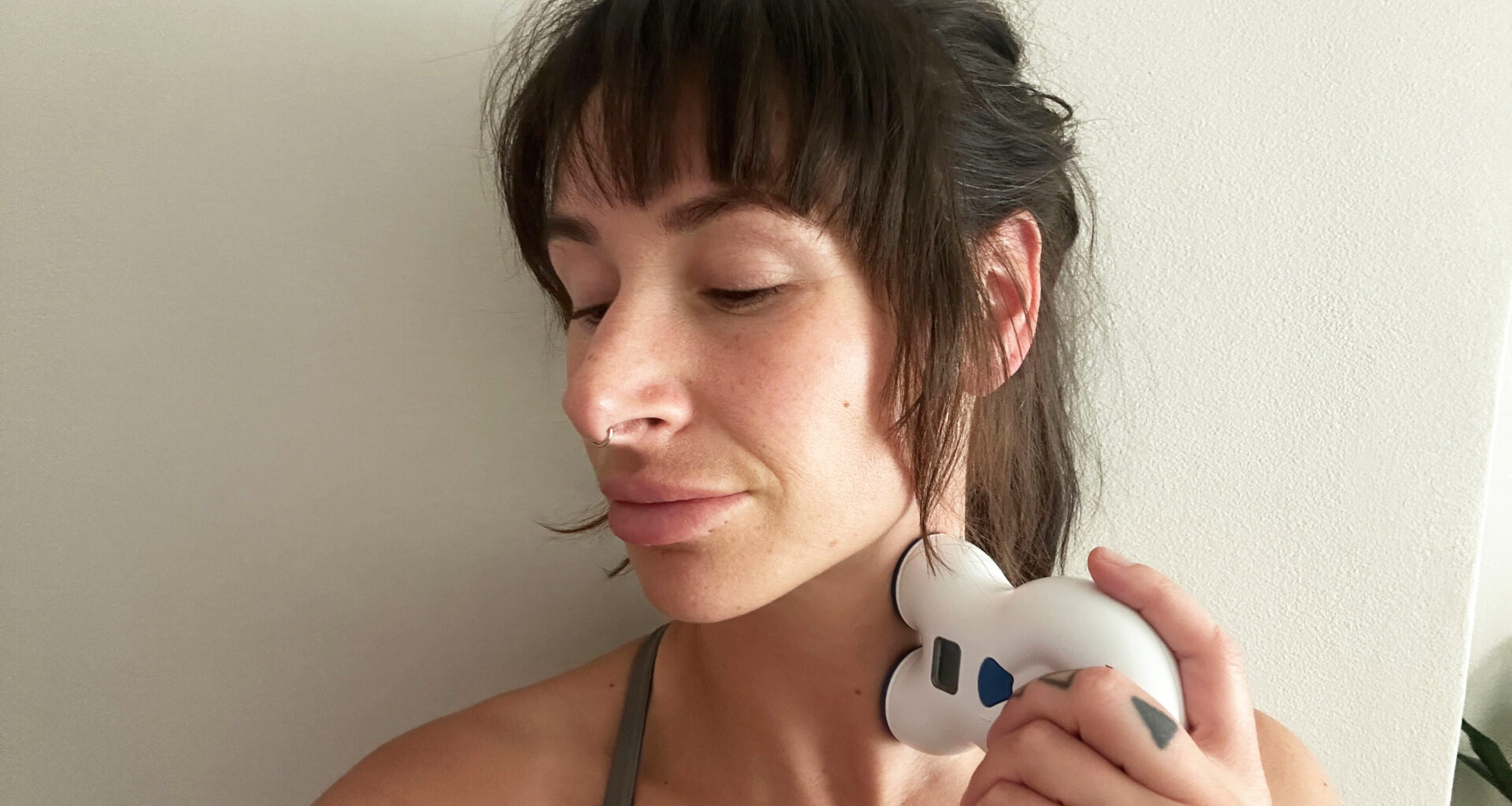 Tester Sam holding VNS to her neck during testing
