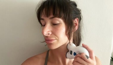 Tester Sam holding VNS to her neck during testing