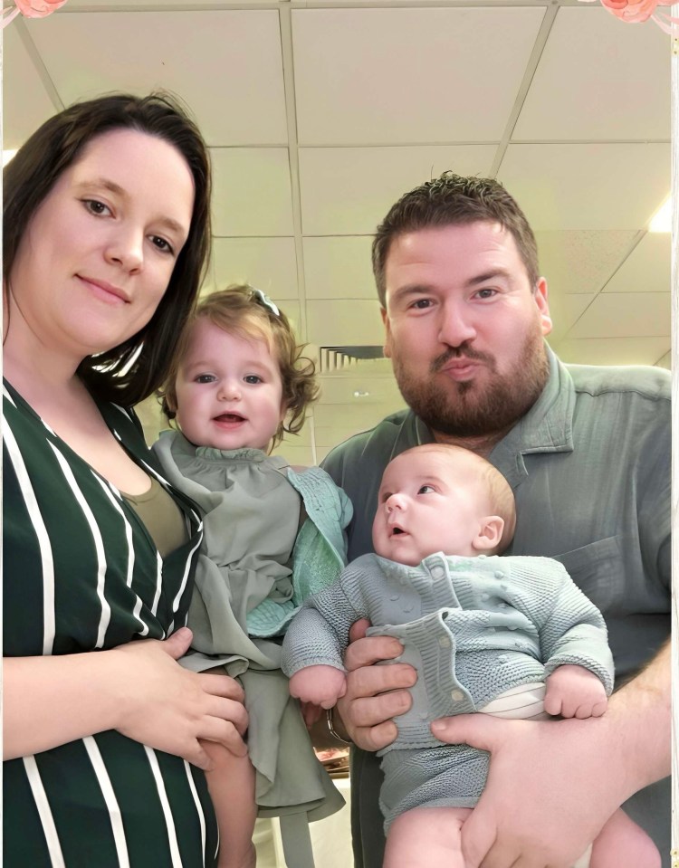 Family portrait of a couple holding their two babies.