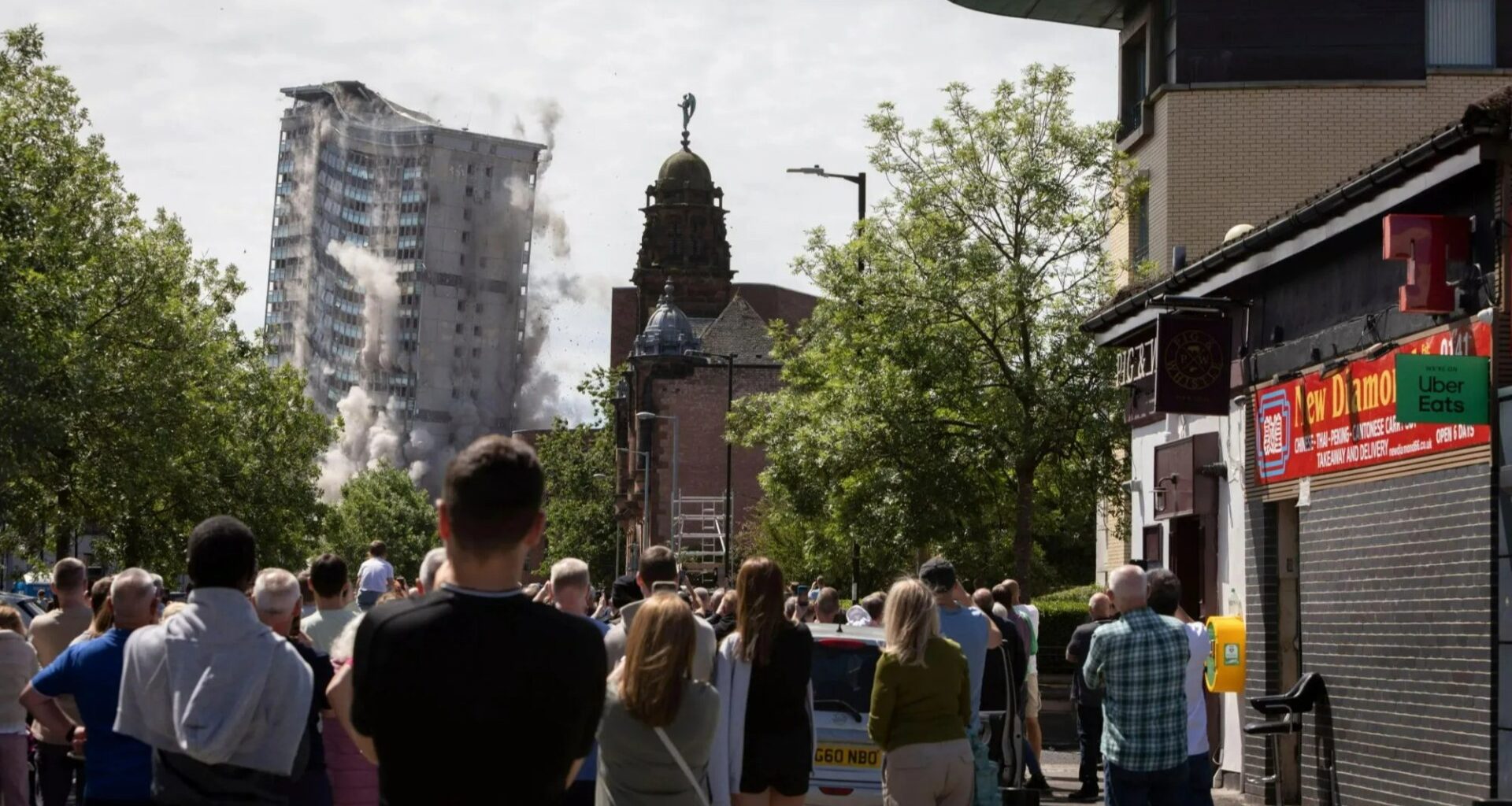 Incredible moment crowd gathers as Glasgow tower blocks are DEMOLISHED in controlled explosion