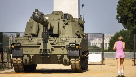 EPA A woman running beside a military vehicle in Washington DC