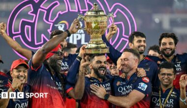Royal Challengers Bengaluru's Virat Kohli, along with his former team-mates AB de Villiers and Chris Gayle, celebrates with the trophy after winning the Indian Premier League.