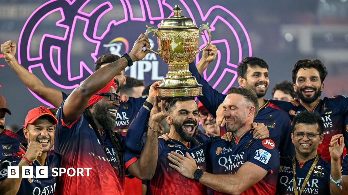 Royal Challengers Bengaluru's Virat Kohli, along with his former team-mates AB de Villiers and Chris Gayle, celebrates with the trophy after winning the Indian Premier League.