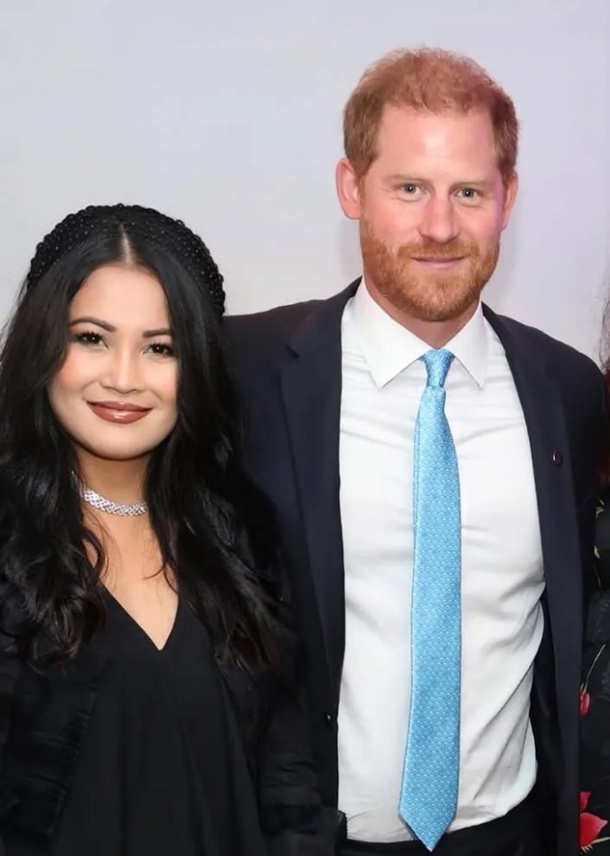 Prince Harry with three women at a charity event.
