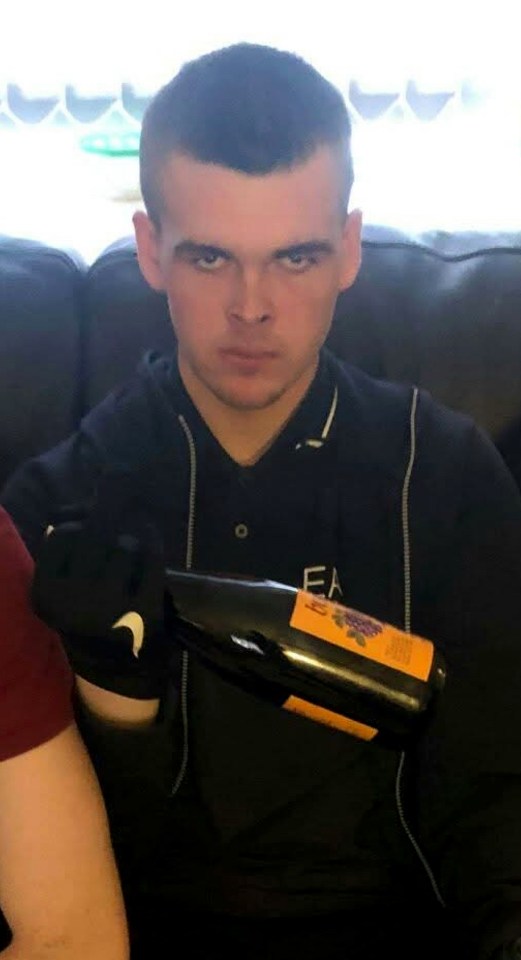 Declan Fulton holding a bottle of wine.