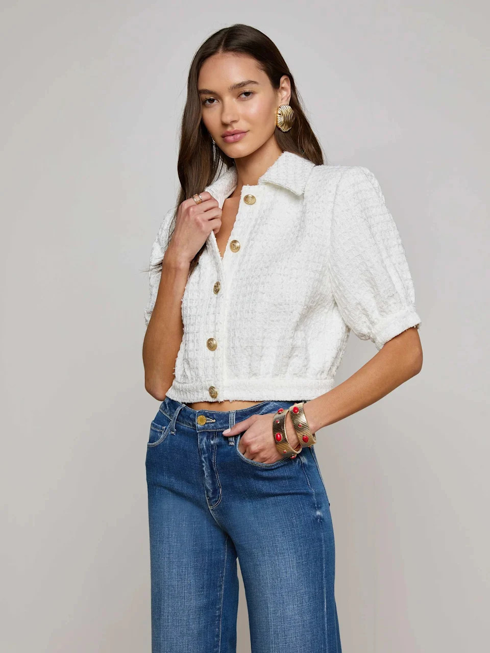 A model wearing a white blazer