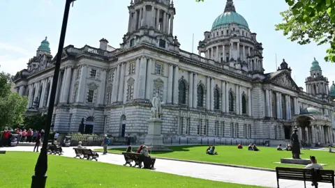 Pacemaker People sitting at Belfast City Hall on a sunny day