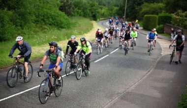 A group of people cycling on a road.
