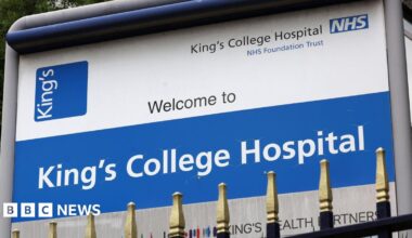 A sign for King's College Hospital, featuring an NHS logo