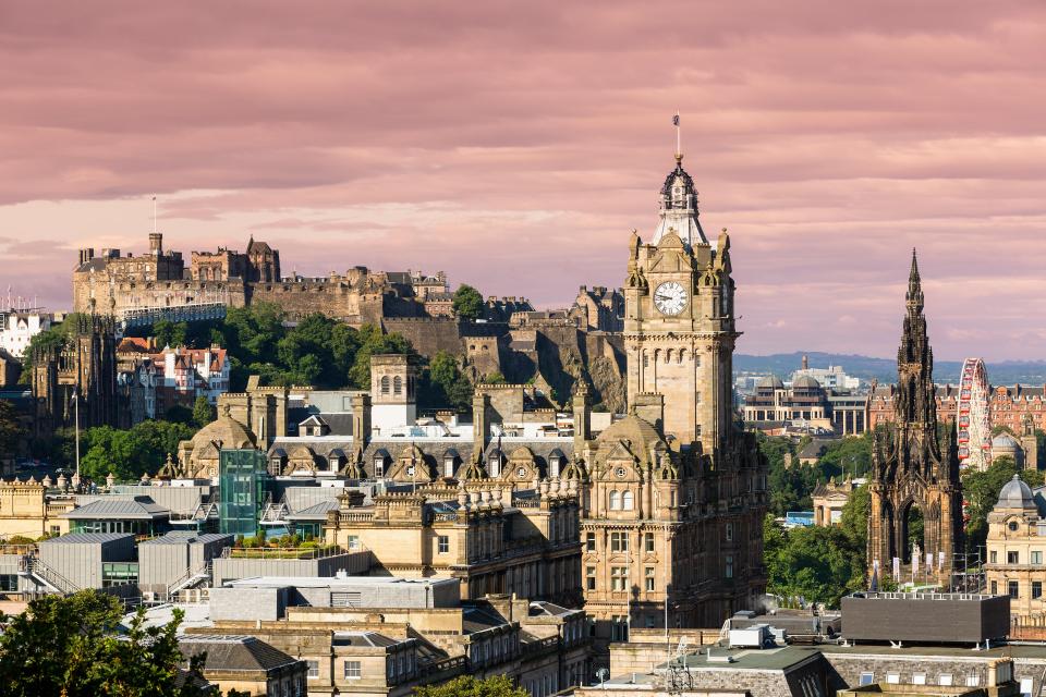 Edinburgh cityscape with castle and clock tower.