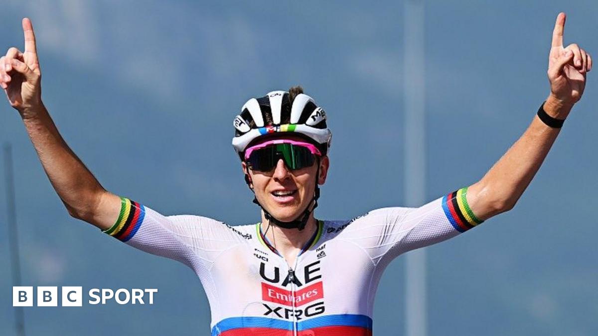 Tadej Pogacar celebrates winning, with both arms raised