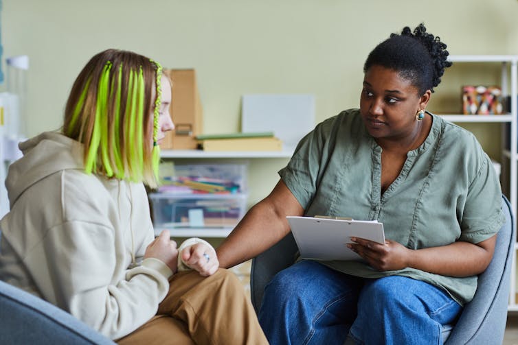 A counsellor supporting a teenager.