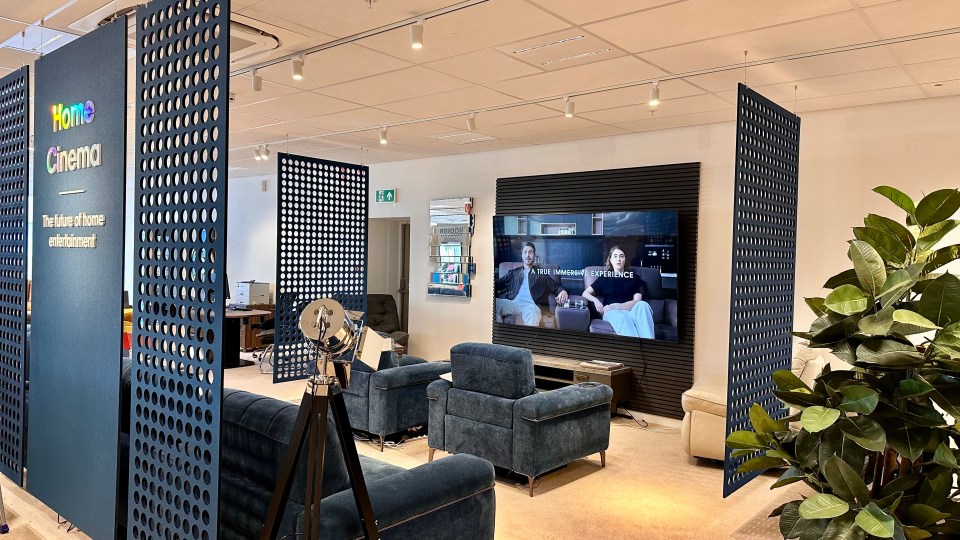 Interior view of a home cinema display area in a furniture store.
