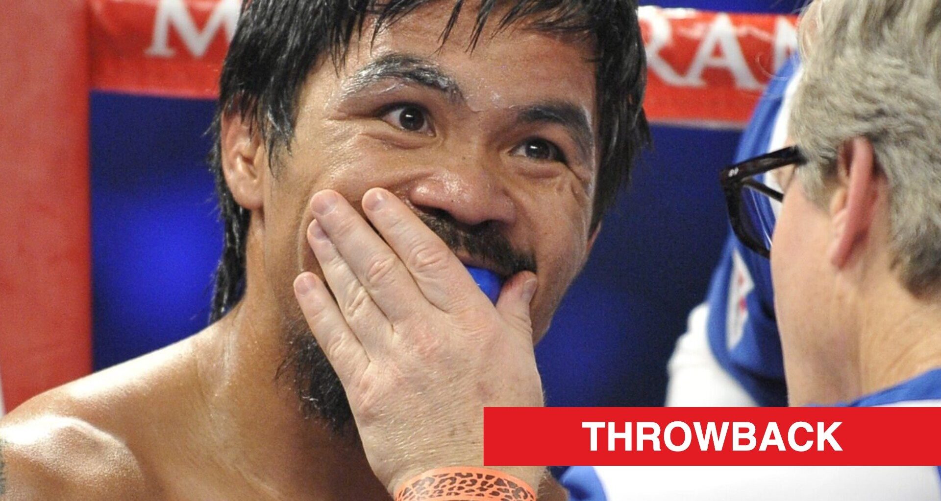 Manny Pacquiao has his gumshield put in by Freddie Roach in his corner