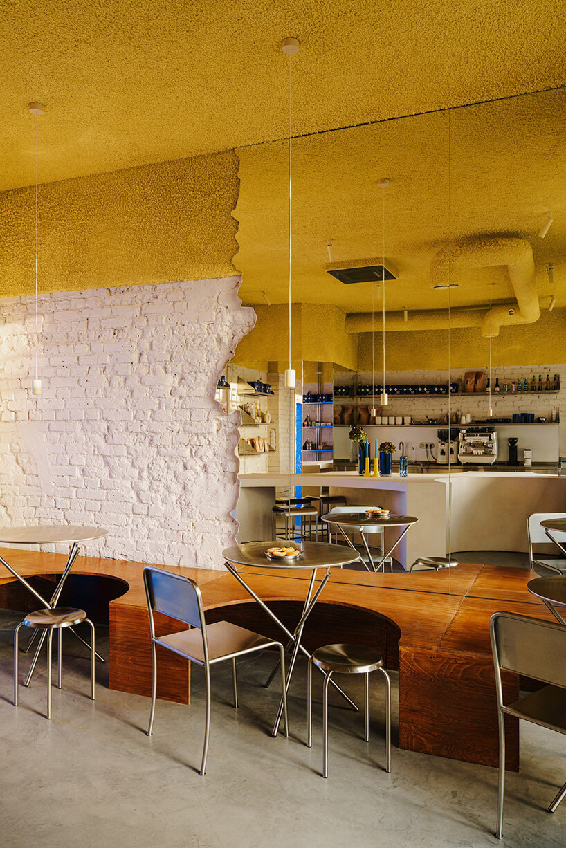 golden ceiling foams above reef-shaped counter in warsaw bakery by znamy się