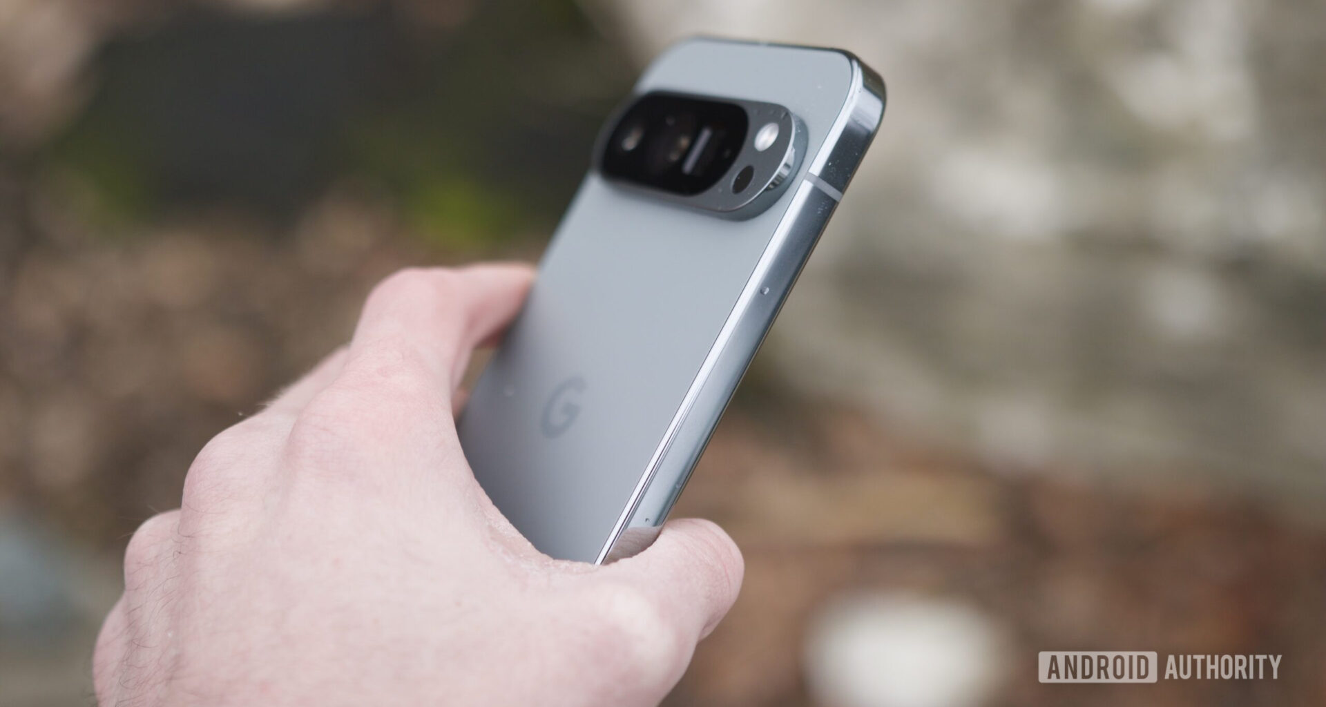 Someone holding the Google Pixel 9 Pro outside.