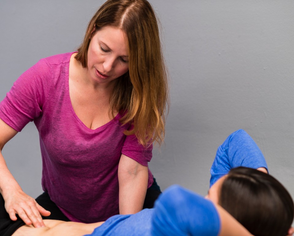 Woman receiving abdominal massage.