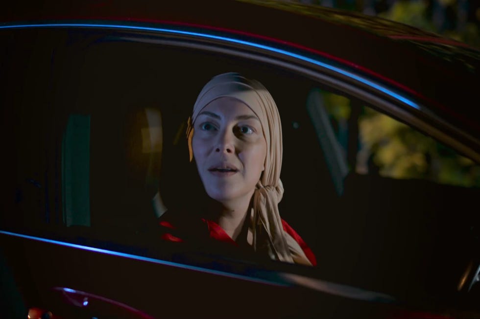 hollyoaks clare devine wearing her headscarf sitting in a car looking out her window