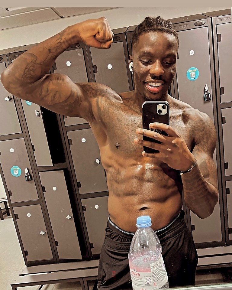 Man flexing in a locker room.