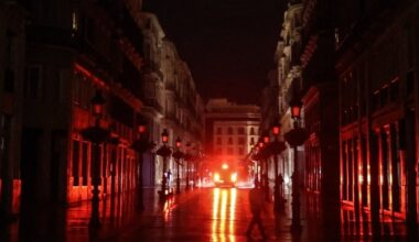 A car drives down a dark street during a blackout in Spain