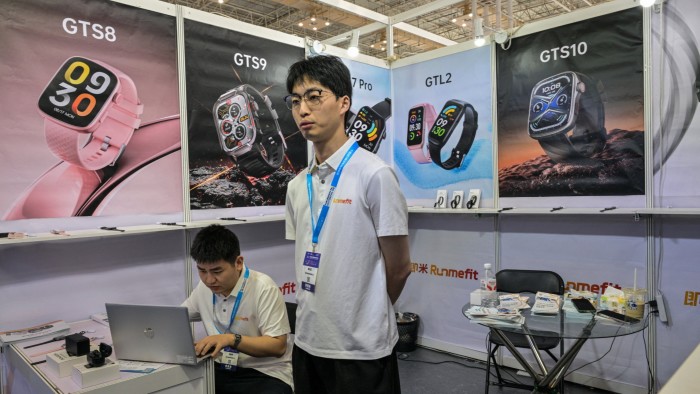 A Chinese watch company employee stands at a trade fair stall in Zhejiang