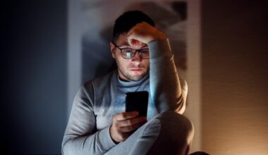 Man on a smartphone in a dark room