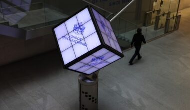 A cube bearing the logo of the London Stock Exchange hangs in the atrium of the company’s building