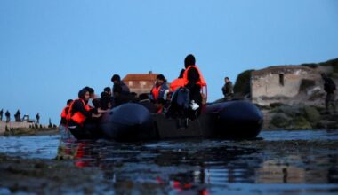 An inflatable dinghy prepares to set out into the English Channel from Ambleteuse, near Calais