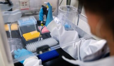A researcher in a laboratory uses genome sequencing equipment