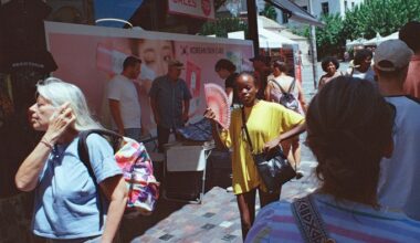 A woman uses a fan to cool herself near Monastiraki Square in Athens, Greece
