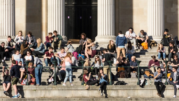 Students sitting on steps at University College London